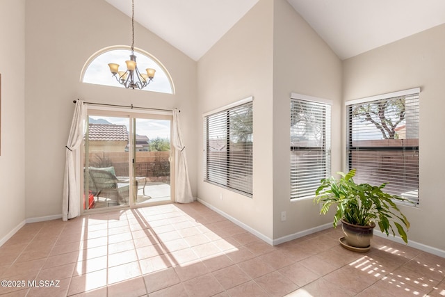 doorway to outside with a chandelier, high vaulted ceiling, baseboards, and light tile patterned floors