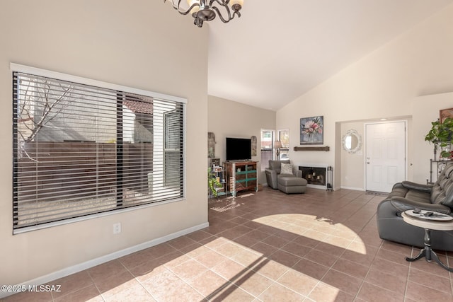 tiled living room featuring high vaulted ceiling, a fireplace, baseboards, and an inviting chandelier