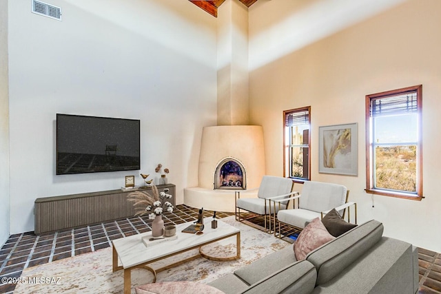 living room with a high ceiling and a fireplace