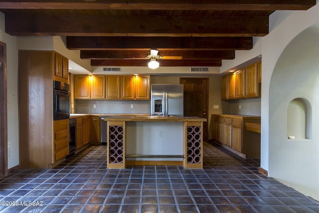 kitchen with black oven, stainless steel fridge with ice dispenser, beam ceiling, a kitchen island, and backsplash