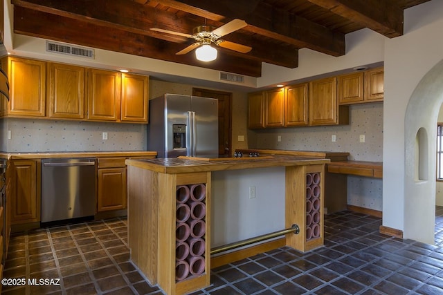 kitchen with ceiling fan, backsplash, beam ceiling, stainless steel appliances, and a center island