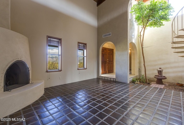 unfurnished living room with a high ceiling