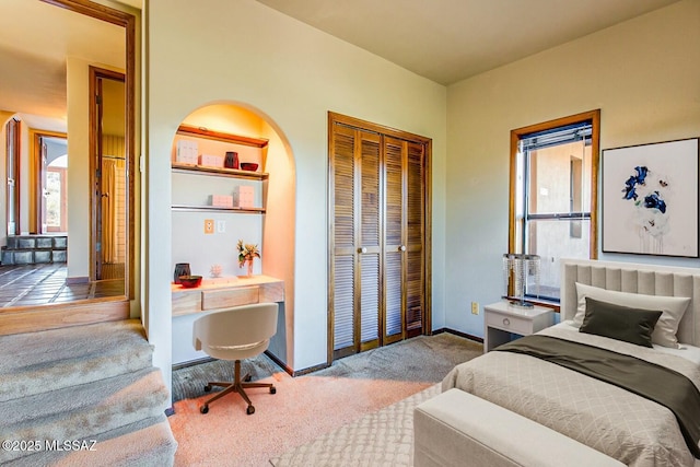 bedroom featuring light carpet and a closet