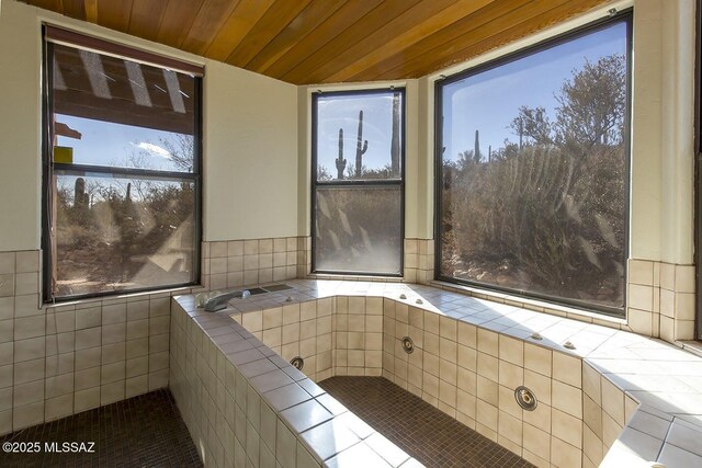 bathroom with vanity and a tile shower