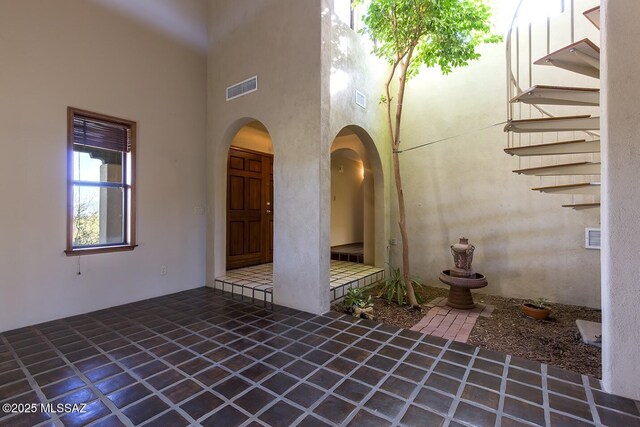 unfurnished sunroom featuring beam ceiling, wooden ceiling, and french doors