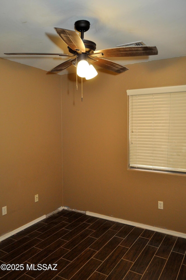 unfurnished room with baseboards, wood finish floors, and ceiling fan