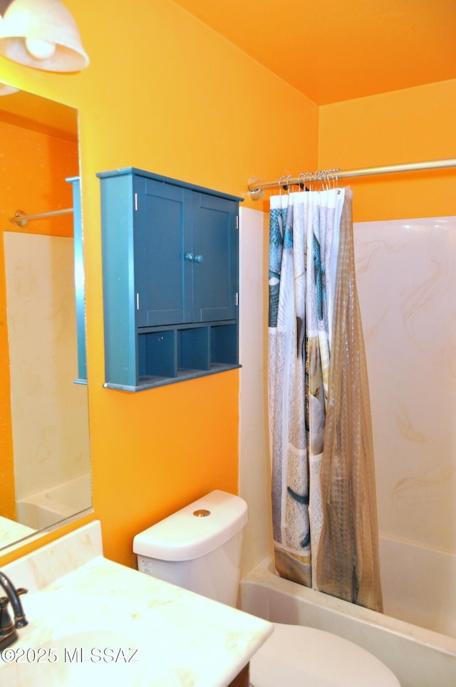 bathroom with vanity, shower / bathtub combination with curtain, and toilet