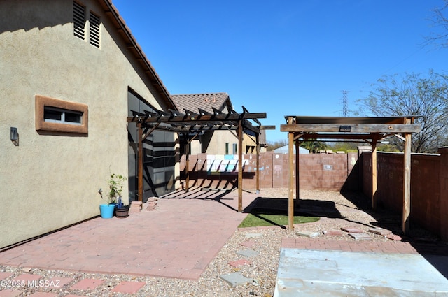 view of patio / terrace with a fenced backyard and a pergola