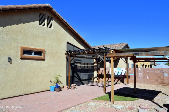 view of patio / terrace with a pergola and fence