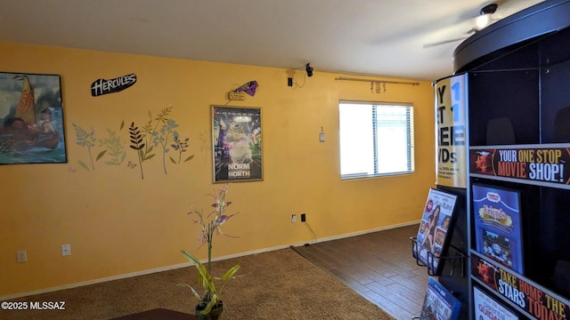 game room featuring wood finished floors and baseboards