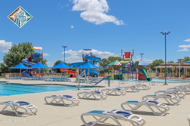 community playground with a community pool, a water play area, and fence