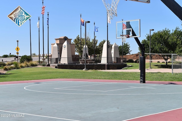 view of sport court with community basketball court, fence, and a yard
