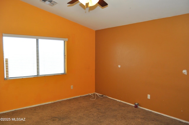 unfurnished room featuring vaulted ceiling, a ceiling fan, carpet floors, baseboards, and visible vents