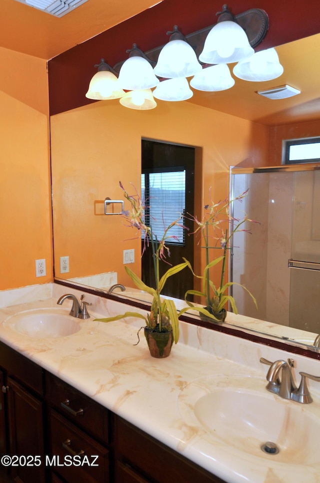 bathroom with vanity and a shower with shower door