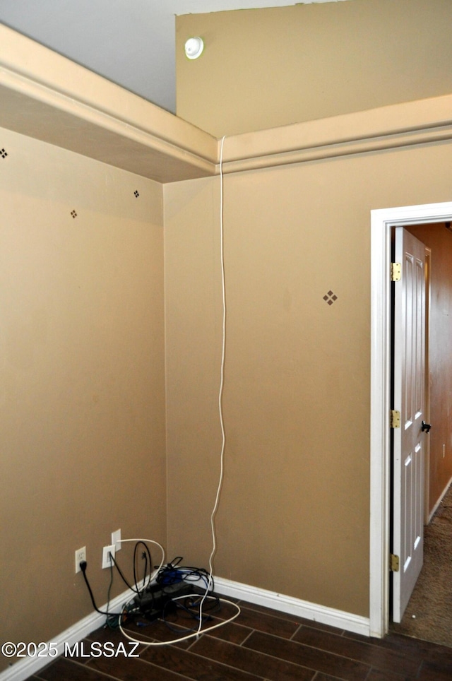 interior space with baseboards and dark wood-type flooring