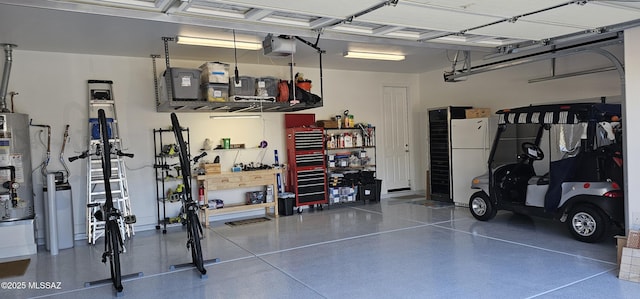 garage featuring a garage door opener, gas water heater, and white refrigerator