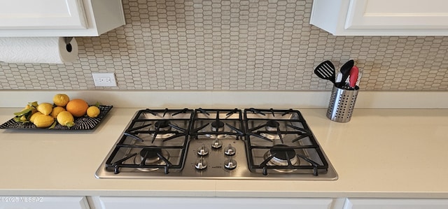 room details featuring white cabinetry and gas stovetop