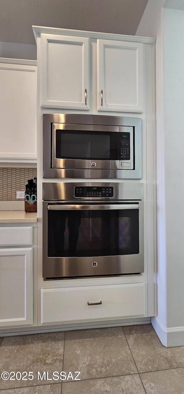 kitchen with appliances with stainless steel finishes and white cabinets