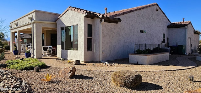 view of side of property featuring a patio area