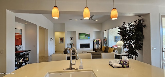 kitchen with ceiling fan, sink, hanging light fixtures, and light tile patterned floors