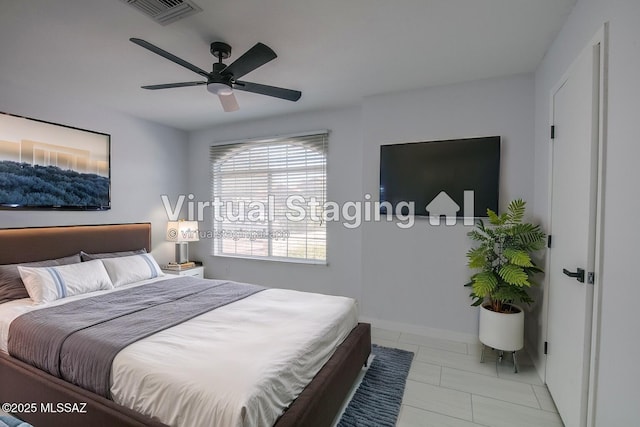 tiled bedroom with visible vents and a ceiling fan