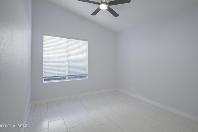 unfurnished room with a ceiling fan, baseboards, and vaulted ceiling