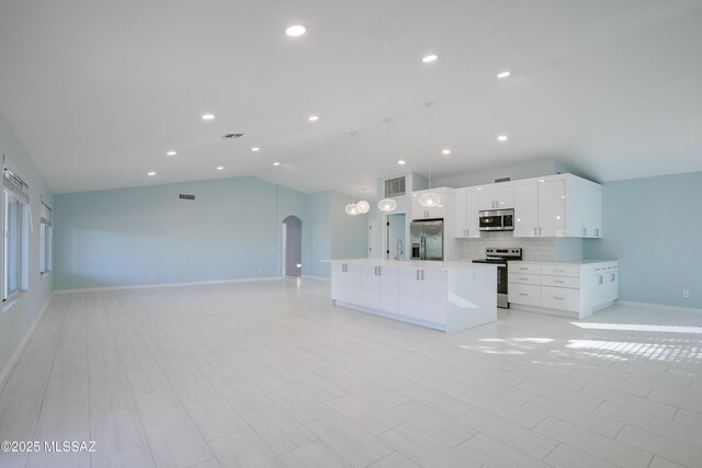 kitchen featuring pendant lighting, appliances with stainless steel finishes, a center island with sink, and white cabinets