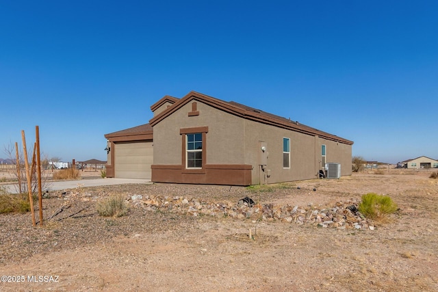 view of home's exterior featuring central AC and a garage