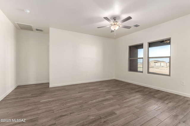 empty room featuring dark wood-type flooring and ceiling fan