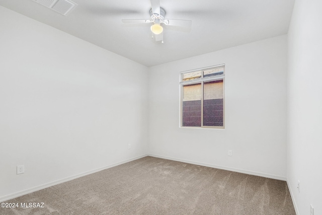 empty room with ceiling fan and carpet flooring