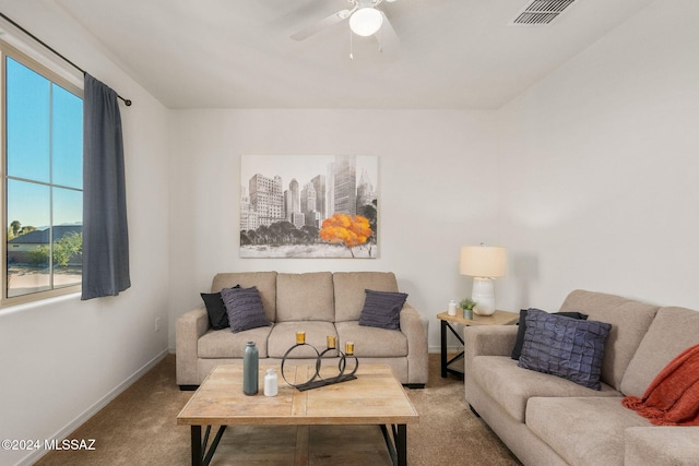 living room with ceiling fan and carpet