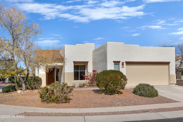 pueblo-style home featuring a garage