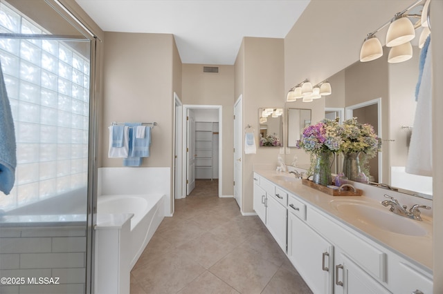 bathroom with vanity, shower with separate bathtub, and tile patterned floors