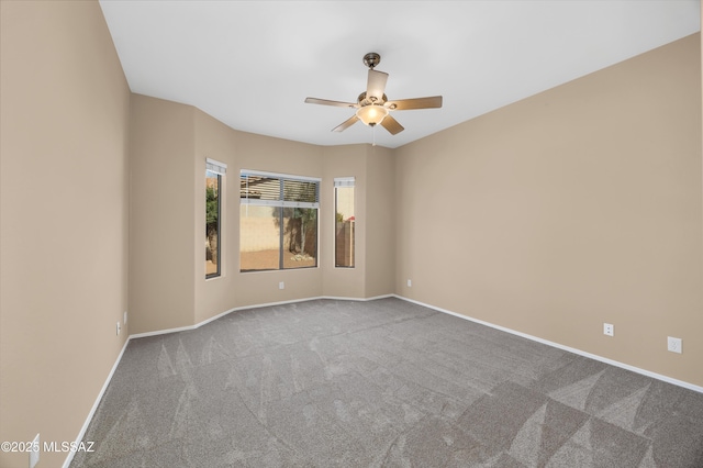 carpeted spare room with ceiling fan