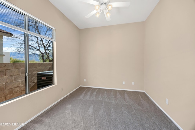 carpeted spare room with ceiling fan