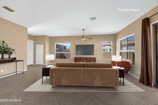 living room featuring ceiling fan, tile patterned floors, and a healthy amount of sunlight