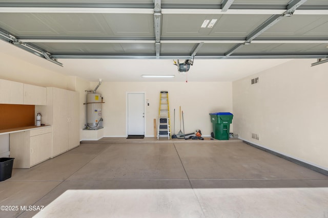 garage featuring a garage door opener and water heater