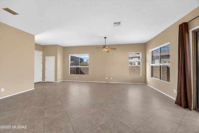 unfurnished room with ceiling fan, light tile patterned floors, and a wealth of natural light