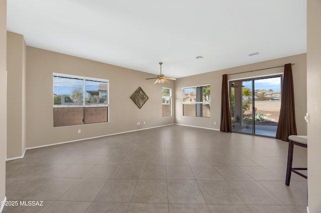 spare room featuring ceiling fan and light tile patterned flooring