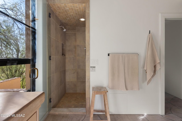 bathroom with vanity and a shower with shower door