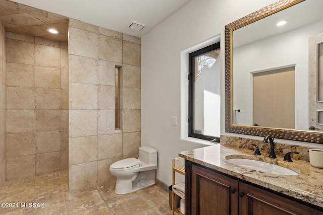 bathroom featuring vanity, walk in shower, and toilet