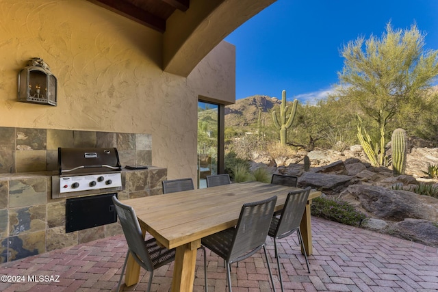 view of patio / terrace with a mountain view and area for grilling