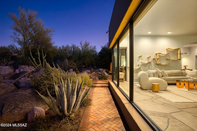 patio terrace at dusk featuring an outdoor living space