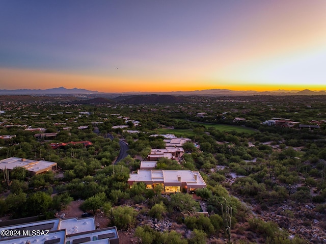 aerial view at dusk featuring a mountain view