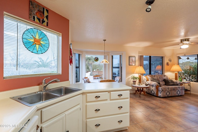 kitchen featuring sink, plenty of natural light, and a textured ceiling