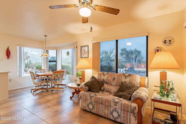 tiled living room featuring ceiling fan