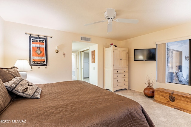 bedroom with light carpet and ceiling fan