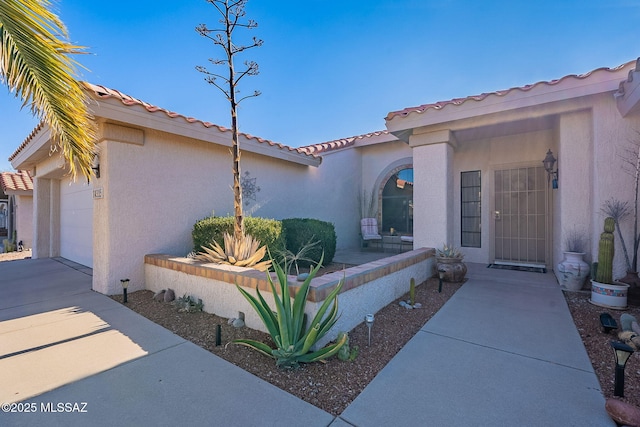 view of exterior entry featuring a garage