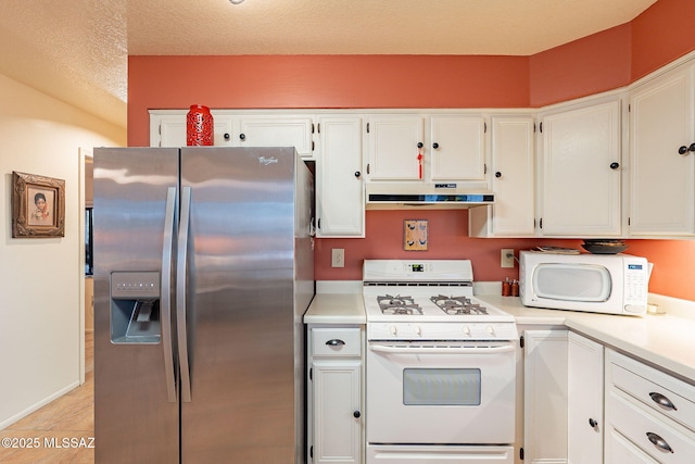 kitchen featuring white appliances and white cabinets