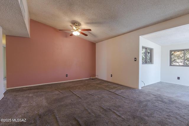 spare room with ceiling fan, lofted ceiling, carpet, and a textured ceiling